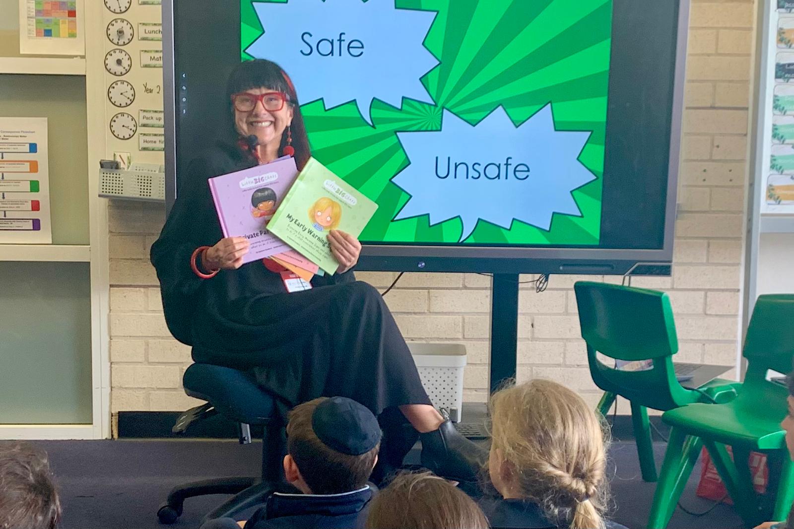Rowena in action during a school program teaching about the importance of using the words safe and unsafe instead of good and bad.
